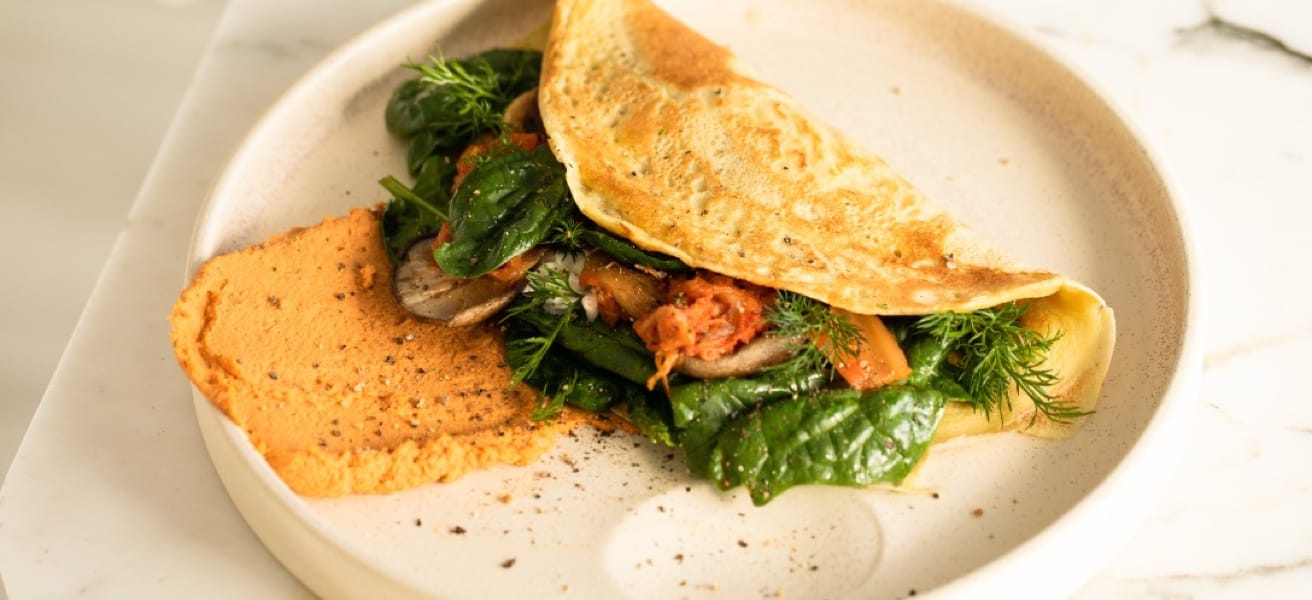 Omelette folded over spinach and mushrooms